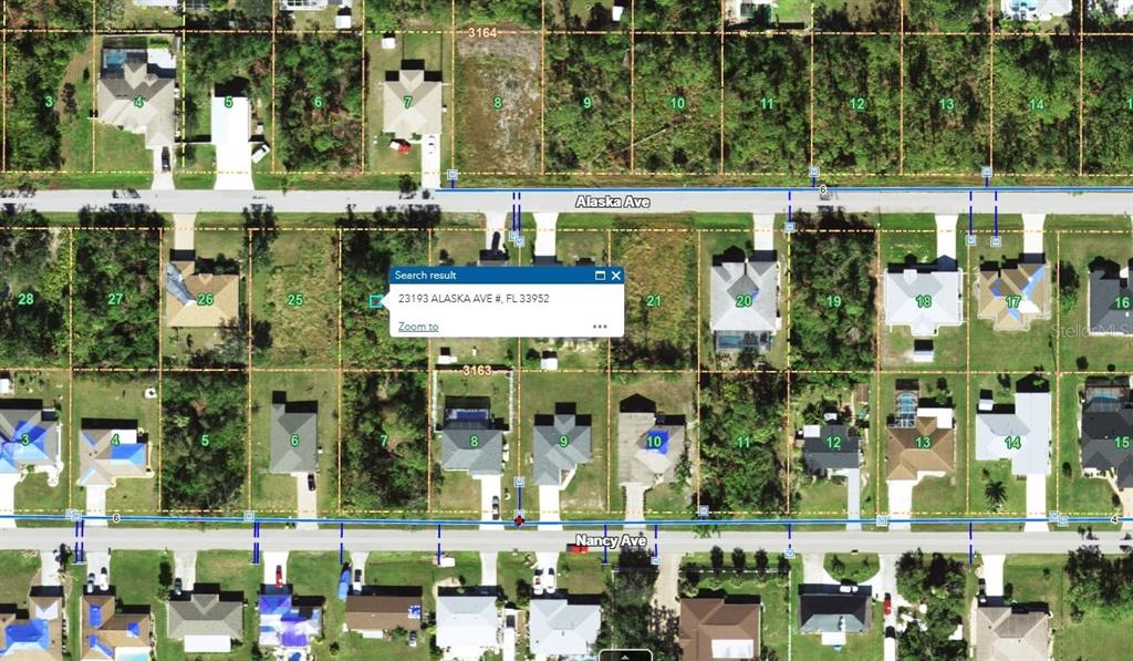 This is an aerial map showing residential lots and houses along Alaska Ave and Nancy Ave — 23193 ALASKA AVENUE, PORT CHARLOTTE, FL