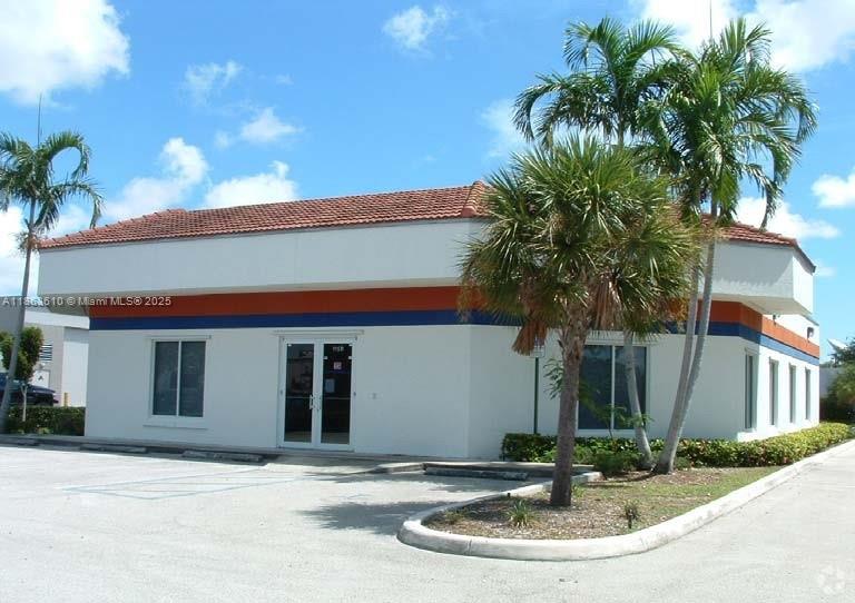 A single-story commercial building with a red tile roof, white walls, and palm trees — 1150 SW 30th Ave, Pompano Beach FL 33069, POMPANO BEACH, FL