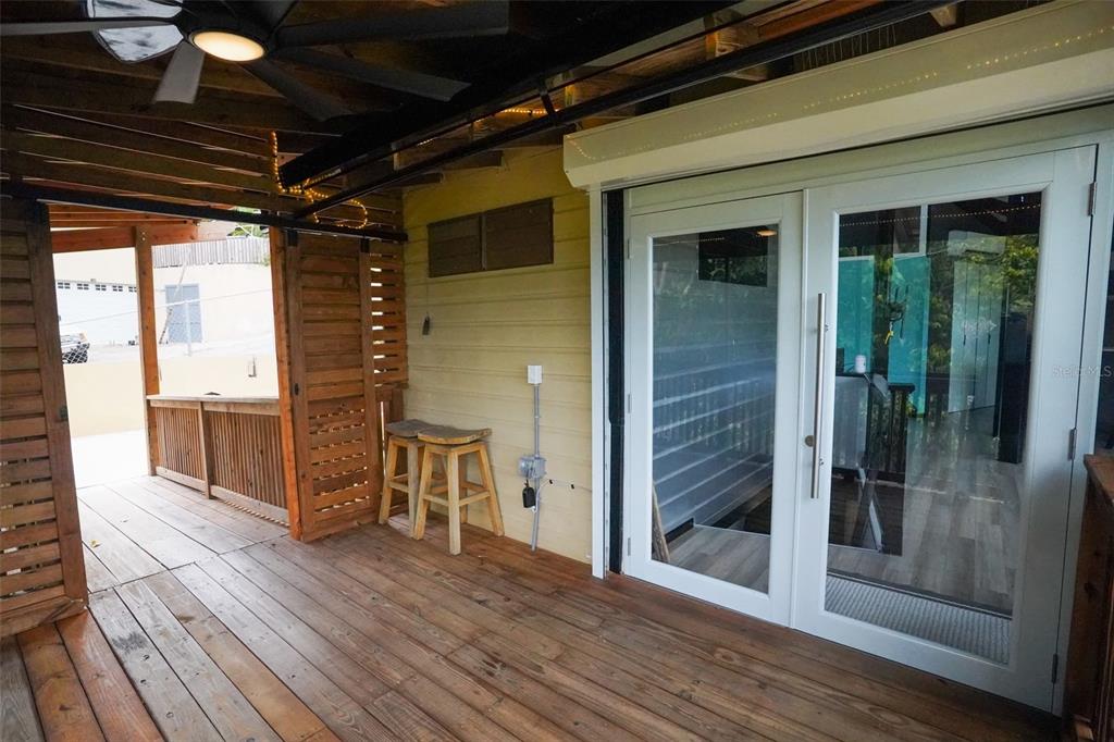 A wooden deck features a ceiling fan, two bar stools, and white French doors — LOT 2 B URB VILLAS DE MONTE VERDE, PONCE, PR