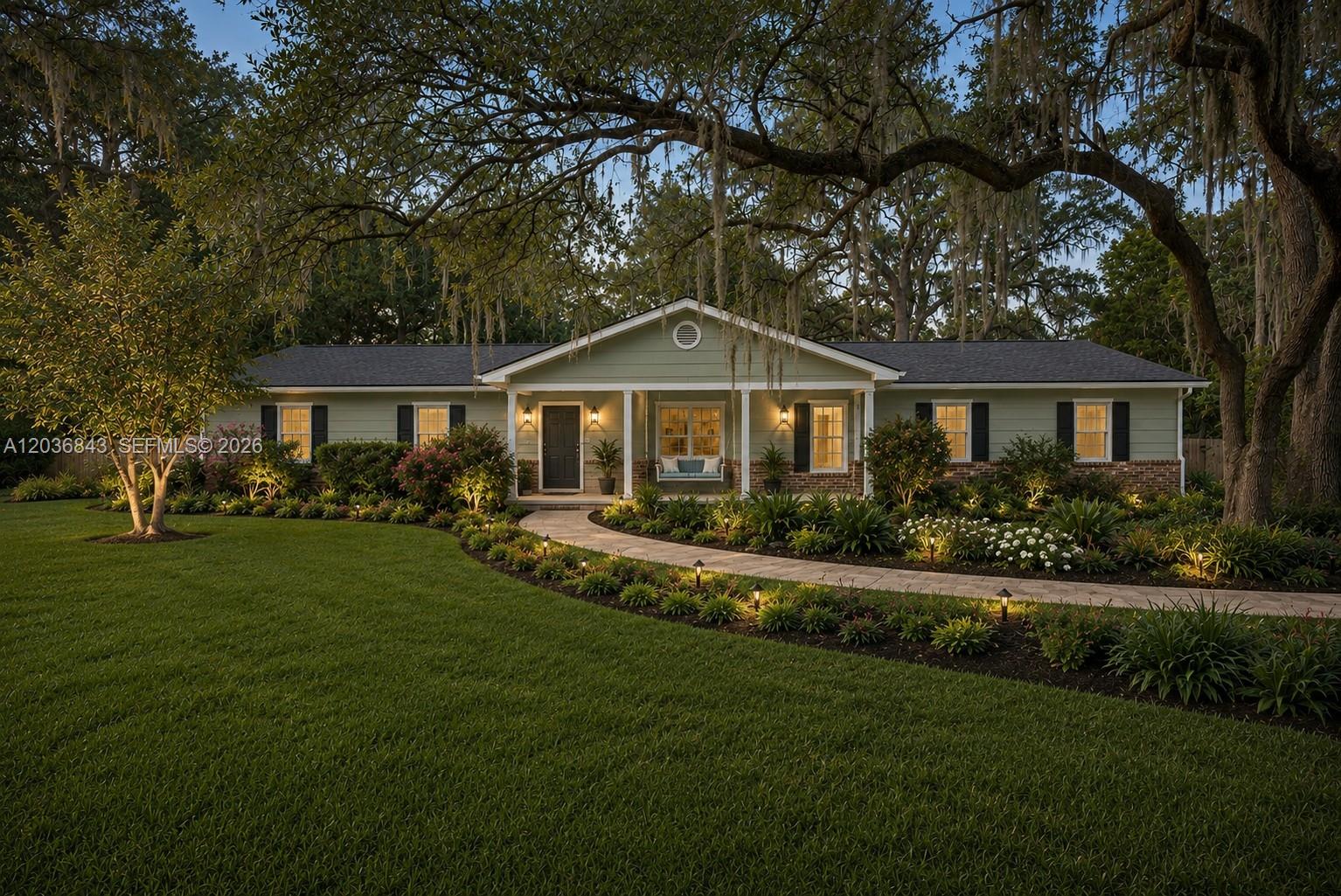 A single-story house with sage green siding, brick accents, and a curved stone walkway — 1944 SW 48th Avenue, Gainesville FL 32608, GAINESVILLE, FL