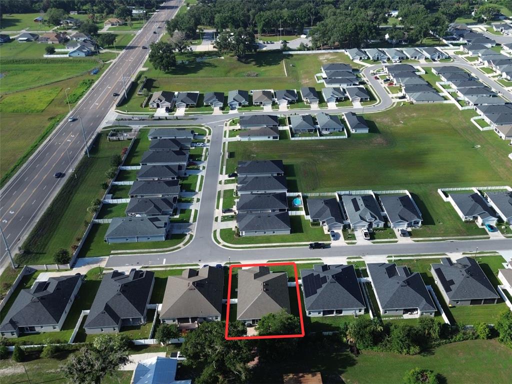 An aerial view shows a residential neighborhood with a highlighted house in the foreground — 6864 MOSSY OAK LANE, LAKELAND, FL