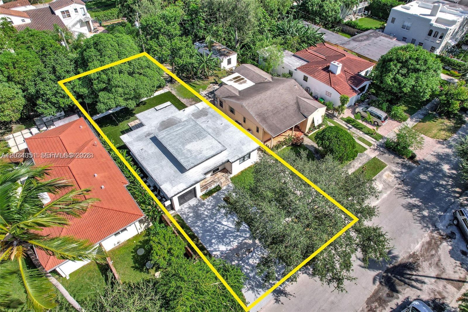 An aerial view shows a single-story house with a flat roof and a paved driveway — EL PORTAL, FL