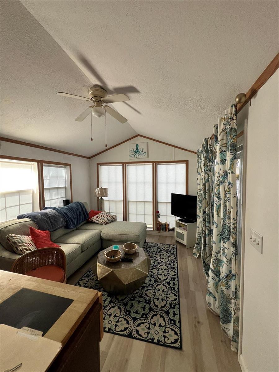 A living room features a sectional sofa, a patterned area rug, and a ceiling fan — 6445 SE 51st Street, Okeechobee FL 34974, OKEECHOBEE, FL