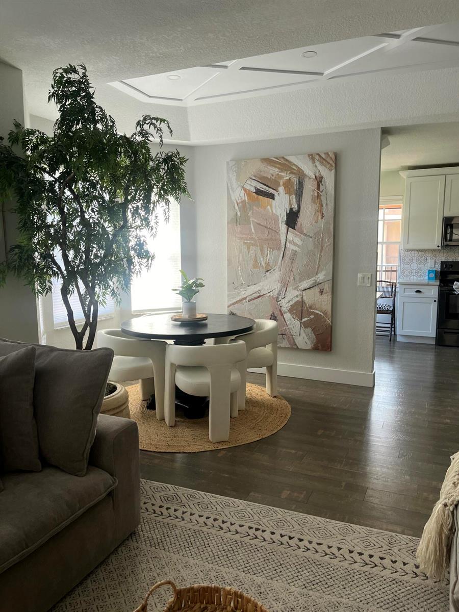 A bedroom features a black bed frame, a chevron accent wall, and a large plant — 1910 Belmont Place, Boynton Beach FL 33436, BOYNTON BEACH, FL