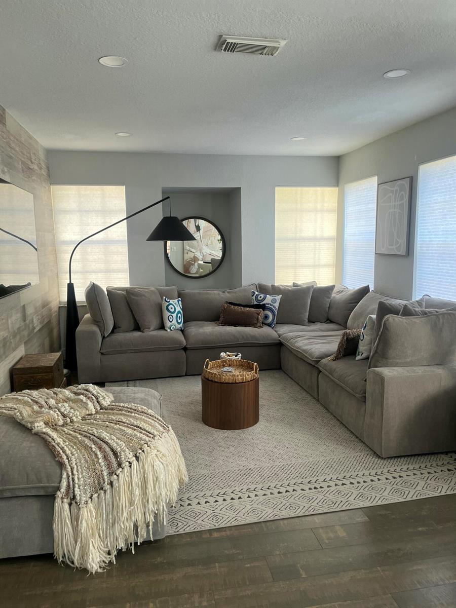 A bedroom features a dark blue French provincial dresser beneath a wall-mounted television — 1910 Belmont Place, Boynton Beach FL 33436, BOYNTON BEACH, FL