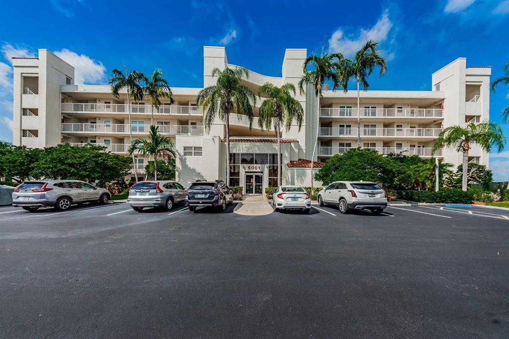 A multi-story white apartment building with palm trees and a parking lot in front — 6001 BAHIA DEL MAR CIRCLE UNIT 527, ST PETERSBURG, FL