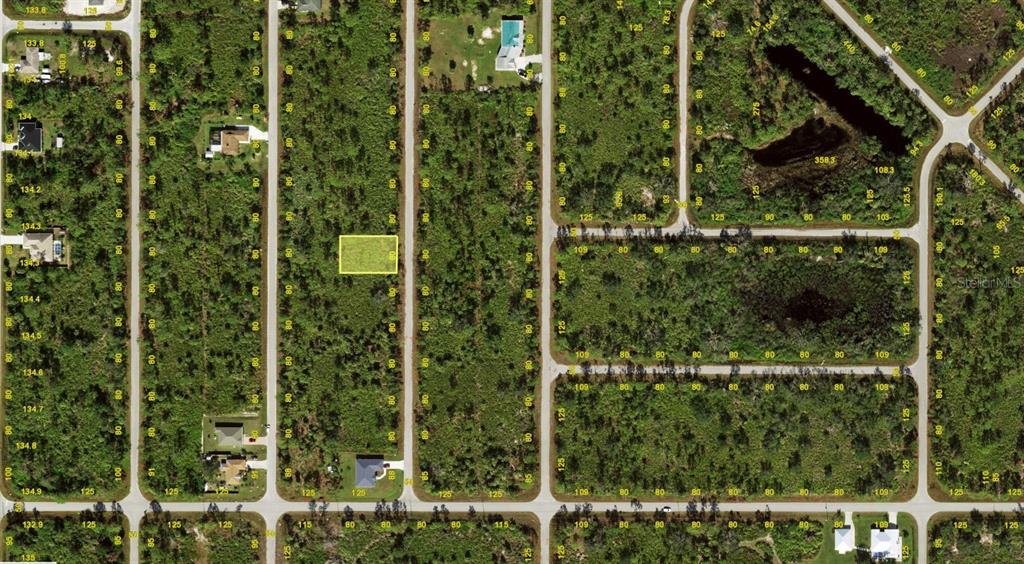 This is an aerial map showing a highlighted vacant lot in a residential subdivision — 3175 DWYER STREET, PORT CHARLOTTE, FL