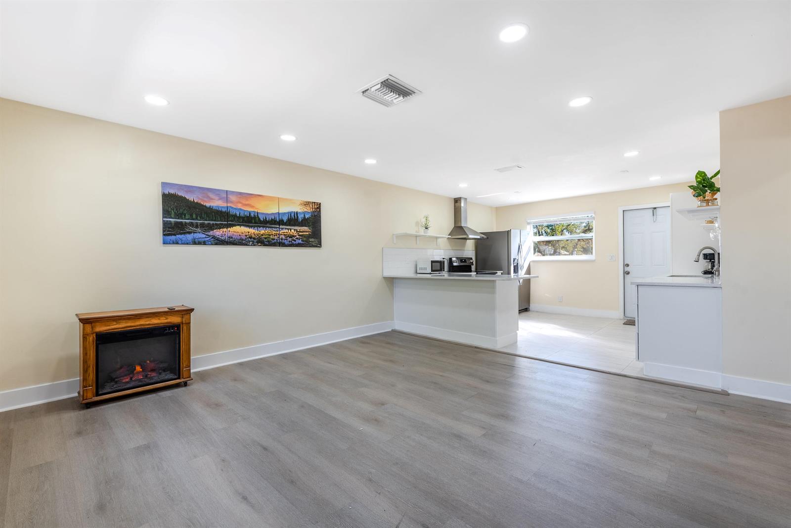 A single-story house with a white garage door, palm trees, and a concrete driveway — 3914 Serubi Avenue, Palm Springs FL 33461, PALM SPRINGS, FL