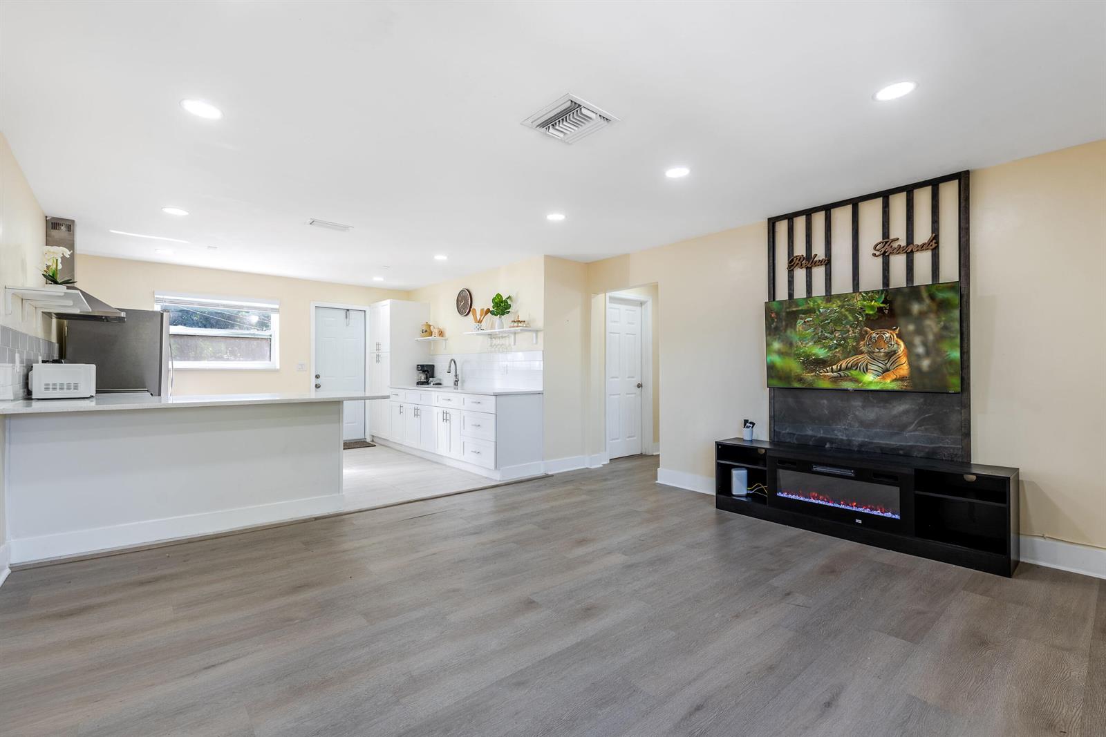 A single-story house with a concrete driveway, palm trees, and a white privacy fence — 3914 Serubi Avenue, Palm Springs FL 33461, PALM SPRINGS, FL
