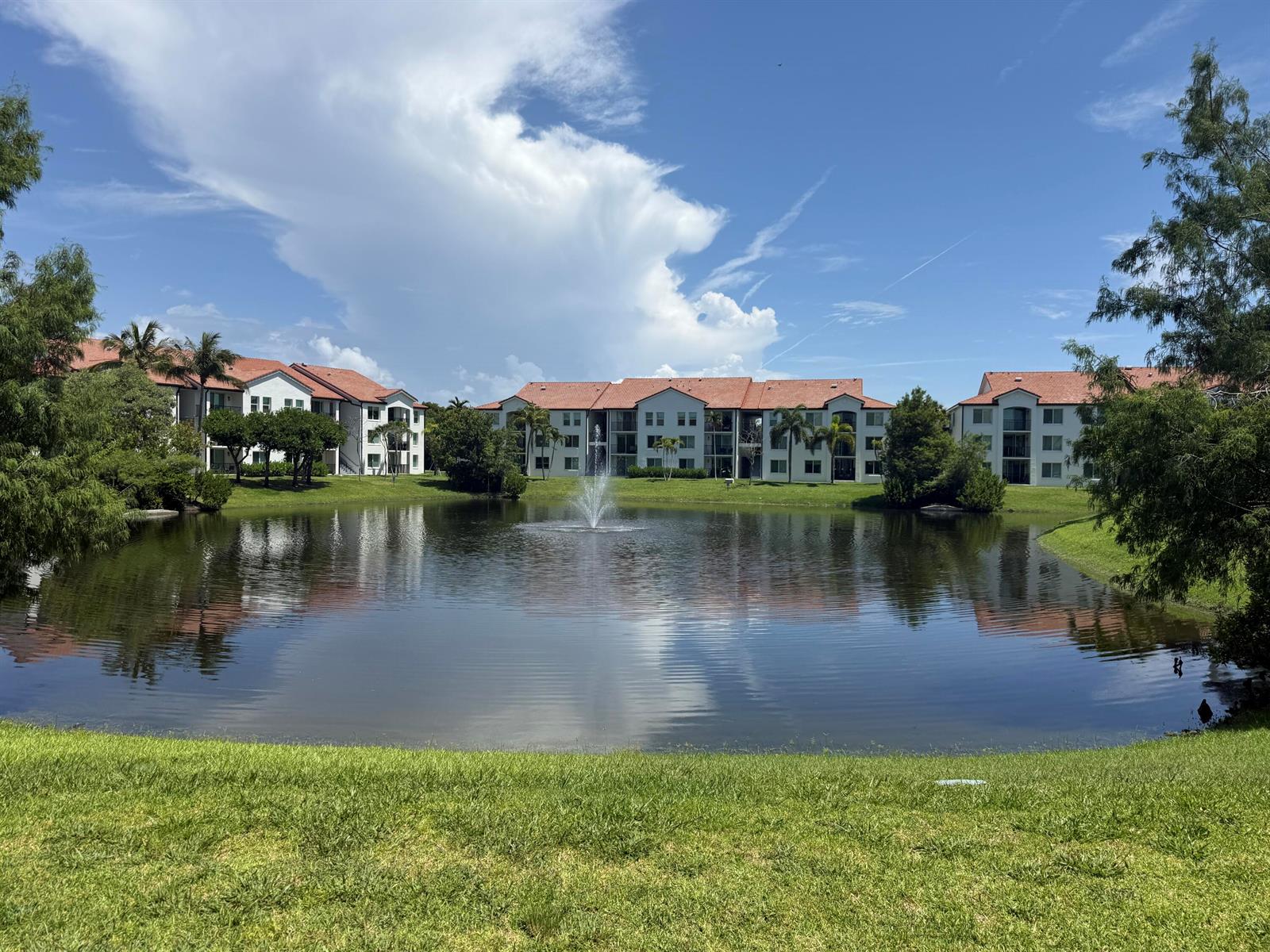 A pond with a fountain sits in front of three multi-story apartment buildings — 902 Villa Circle, Boynton Beach FL 33435, BOYNTON BEACH, FL