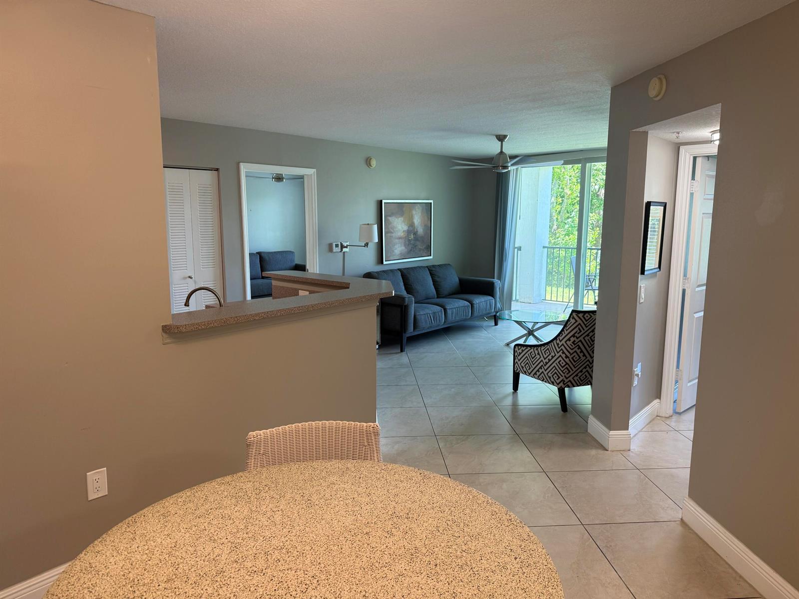 A view from a dining area looking into a living room with tile flooring — 902 Villa Circle, Boynton Beach FL 33435, BOYNTON BEACH, FL