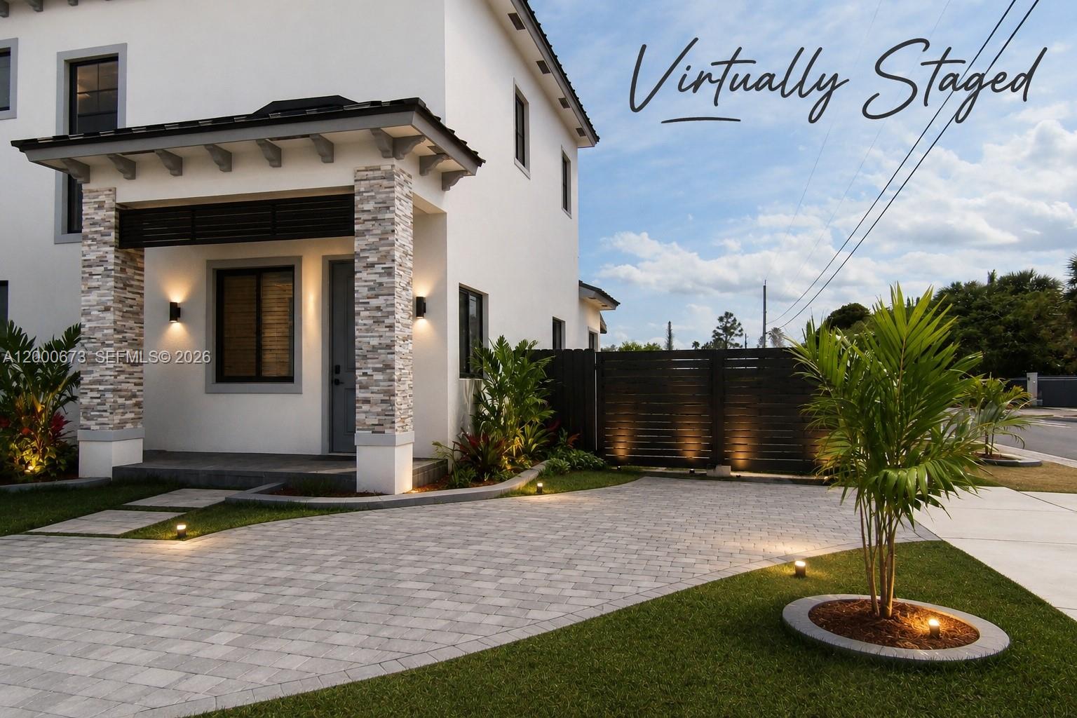 A modern two-story house with a stone-accented porch, paved driveway, and landscape lighting — 11998 SW 232nd St, Miami FL 33170, MIAMI, FL