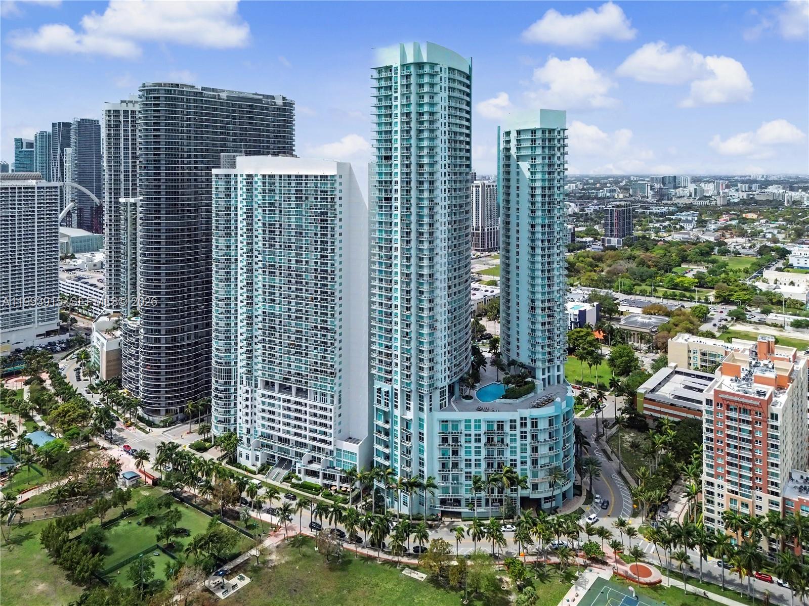 An aerial view of several high-rise residential towers surrounded by palm trees and city streets — 1900 N Bayshore Dr # 3811, Miami FL 33132, MIAMI, FL