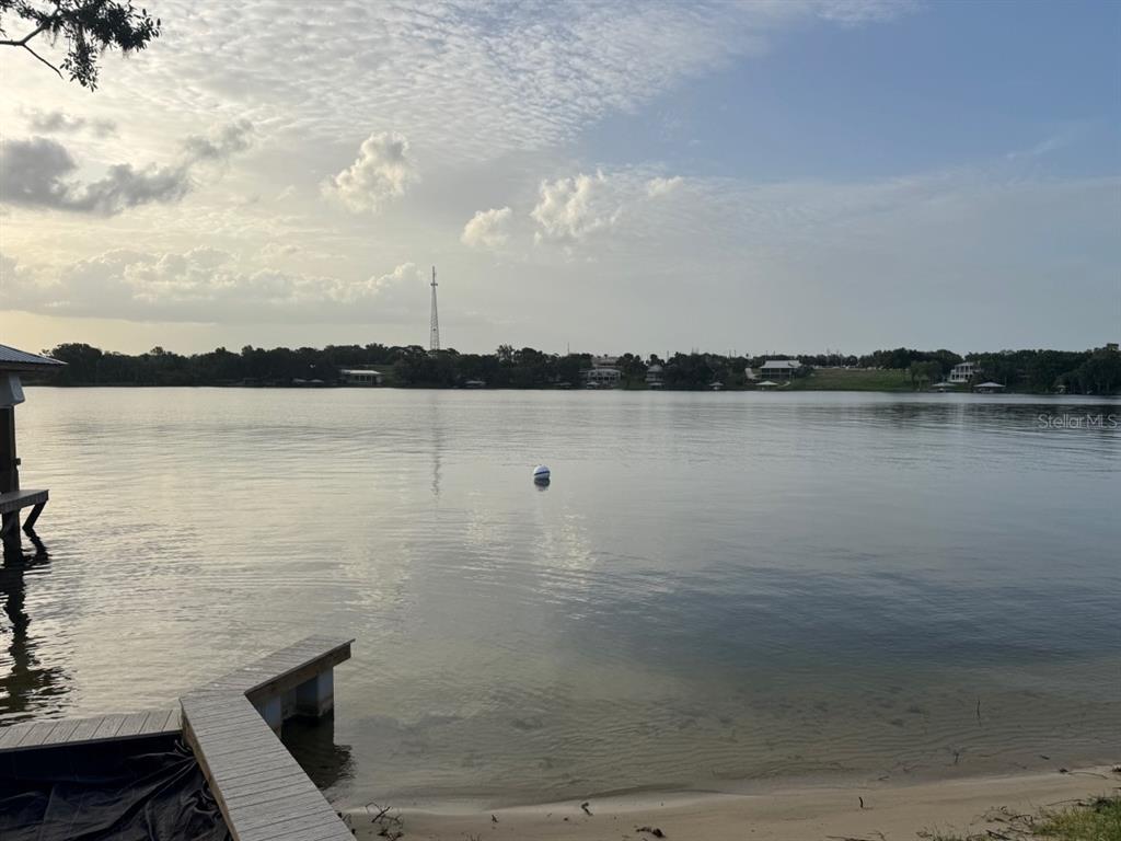 A wooden dock extends into a calm lake under a cloudy sky — 1232 CR 17 ROAD N, LAKE PLACID, FL