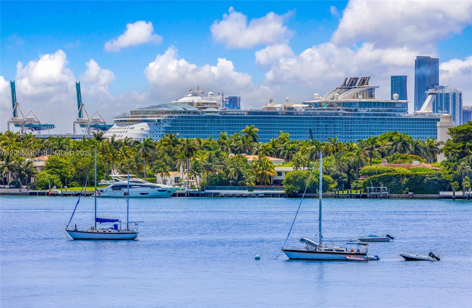 A large cruise ship is docked behind a waterfront area with sailboats and palm trees — 1000 West Ave # 426, Miami Beach FL 33139, MIAMI BEACH, FL