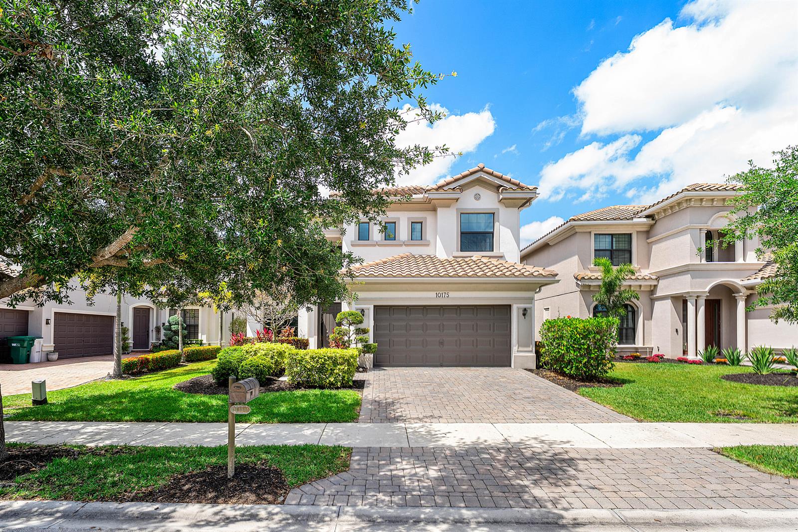 A two-story suburban house with a tiled roof, a two-car garage, and a paved driveway — 10175 Cameilla Street, Parkland FL 33076, PARKLAND, FL