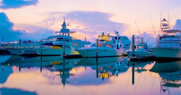 Several yachts are docked in a calm marina during a colorful sunset — Dolphin # 8 Fisherman Village Marina., ., .