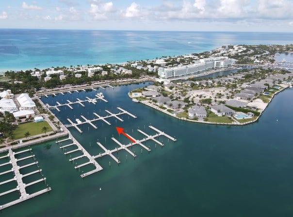 An aerial view of a marina with multiple boat slips and a red arrow pointing toward one — Dolphin # 8 Fisherman Village Marina., ., .