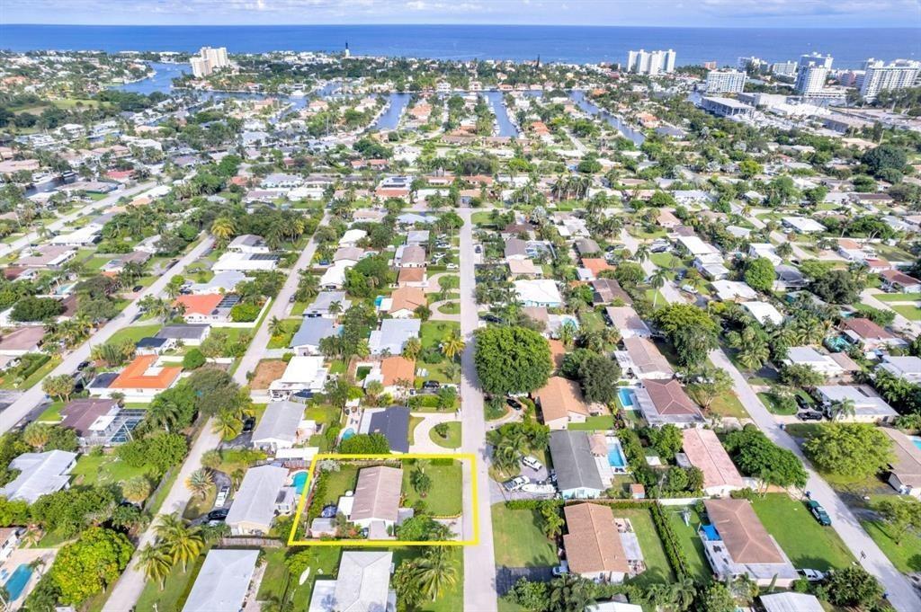 An aerial view shows a single-story house with a yellow outline in a residential neighborhood — 2611 NE 20th Street, Pompano Beach FL 33062, POMPANO BEACH, FL