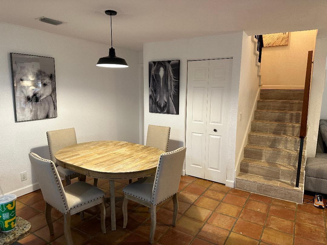 A dining area features a round wooden table, four upholstered chairs, and two horse portraits — 1608 Shaker Circle, Wellington FL 33414, WELLINGTON, FL
