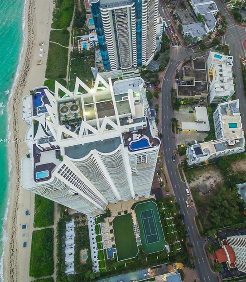 Aerial view of a high-rise residential building with rooftop pools and a tennis court — 6365 Collins Ave # 904, Miami Beach FL 33141, MIAMI BEACH, FL