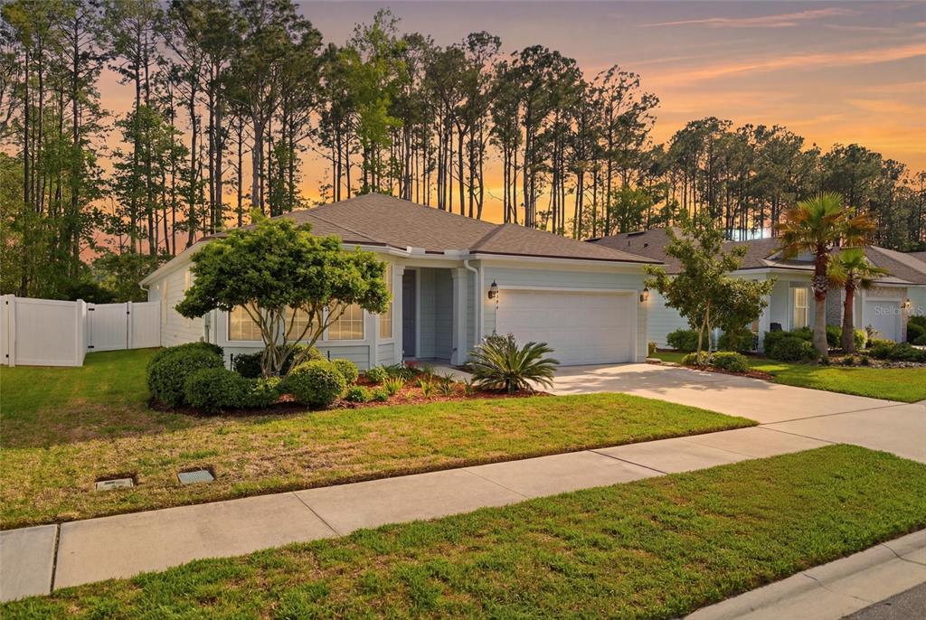 A light-colored single-story house with a two-car garage and a landscaped front yard — 4594 FARMHOUSE GATE TRAIL, JACKSONVILLE, FL