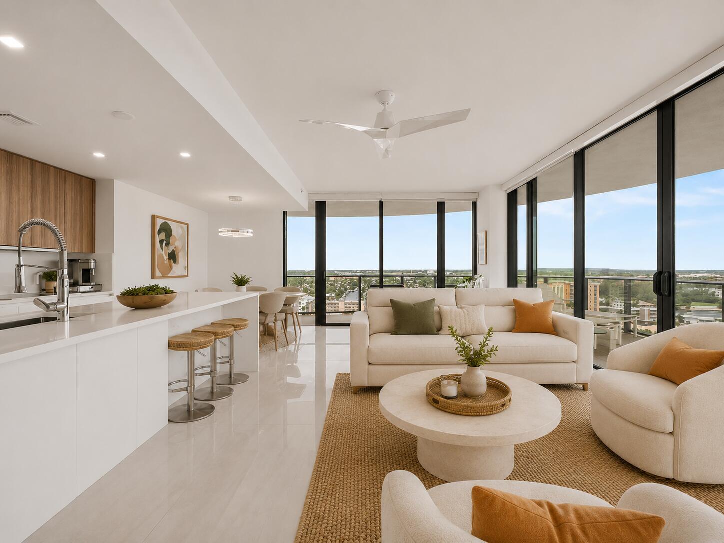 A modern open-concept living room and kitchen with floor-to-ceiling windows and neutral furnishings — 730 N Ocean Boulevard, Pompano Beach FL 33062, POMPANO BEACH, FL
