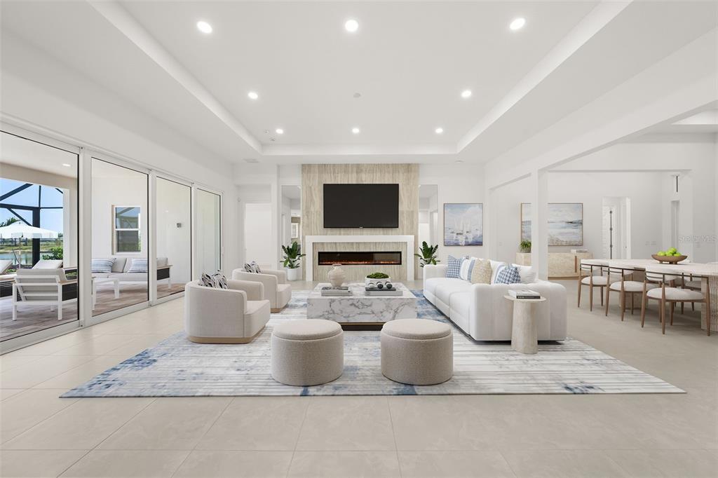 A modern living room features a fireplace, large sliding glass doors, and a dining area — 844 BLUE SHELL LOOP, SARASOTA, FL