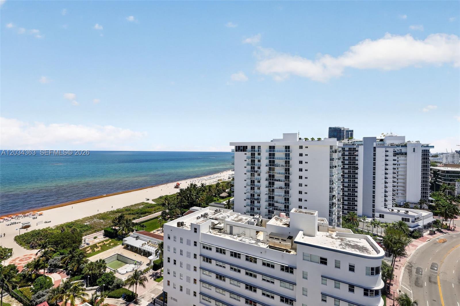 An elevated view shows a beach, ocean, and several white apartment buildings along a road — 2555 Collins Ave # 1812, Miami Beach FL 33140, MIAMI BEACH, FL