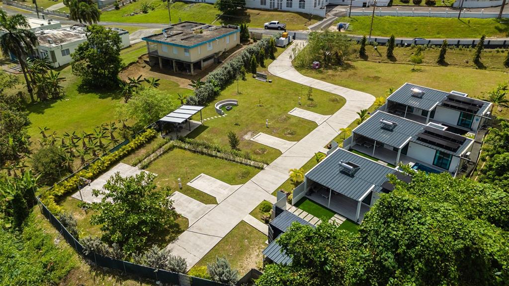 An aerial view shows a modern residential property with three connected buildings and landscaped grounds — PR-967 BO JIMENEZ KM. 1.5, RIO GRANDE, PR
