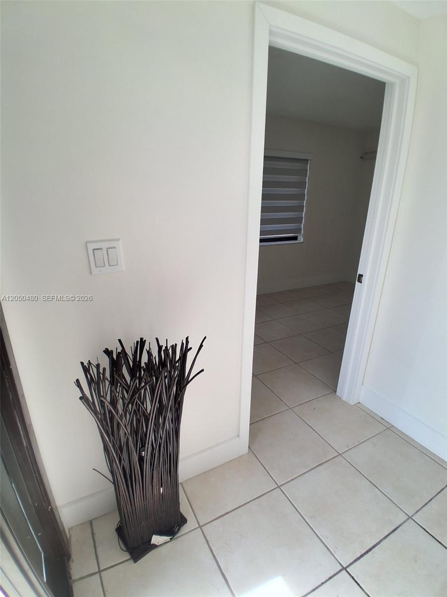 A light-colored room with tiled floors leads into another room through a doorway — 1231 SW 136th Pl # A, Miami FL 33184, MIAMI, FL
