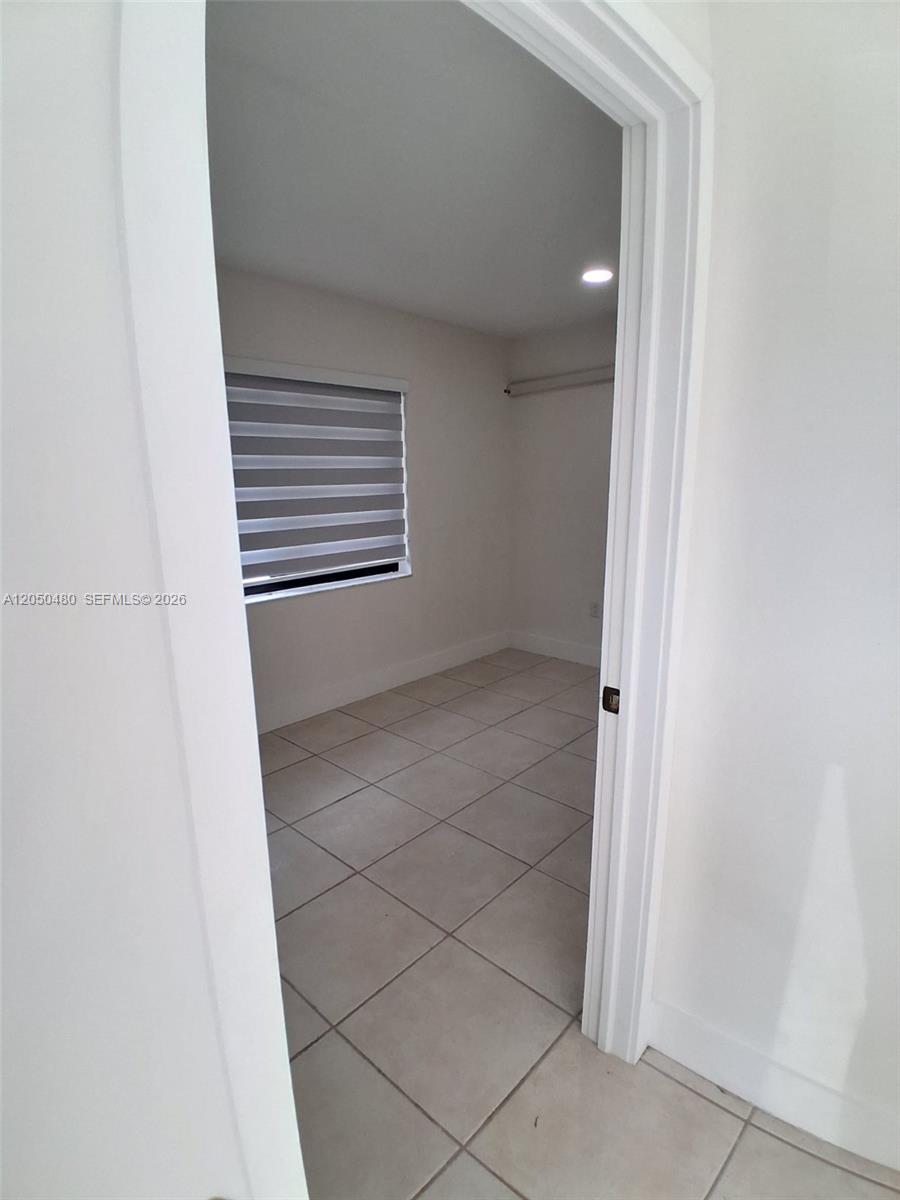 A small room with light-colored tile flooring and a window with striped blinds — 1231 SW 136th Pl # A, Miami FL 33184, MIAMI, FL