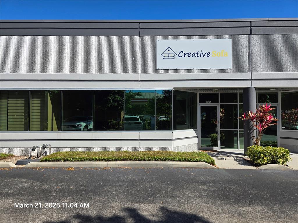 The exterior of a commercial building features a sign for Creative Sofa above a glass entrance — 7901 KINGSPOINTE PARKWAY UNIT 23, ORLANDO, FL