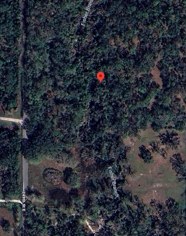 This is a satellite map view showing a wooded lot with a red location pin — 5011 249TH ST STREET E, MYAKKA CITY, FL