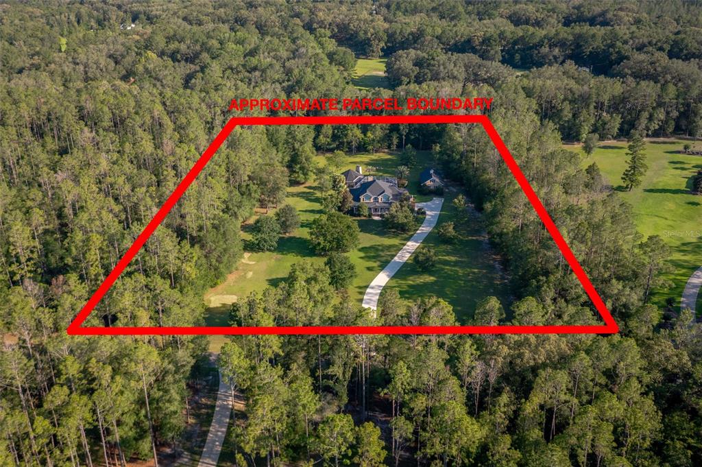 An aerial view shows a house with a long driveway surrounded by trees and grass — 19103 NW 72ND AVENUE, ALACHUA, FL