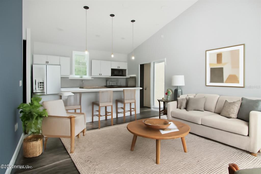 This is a digital rendering of an open-concept living room and kitchen with neutral furniture — 225 GARDENIA AVENUE, GEORGETOWN, FL