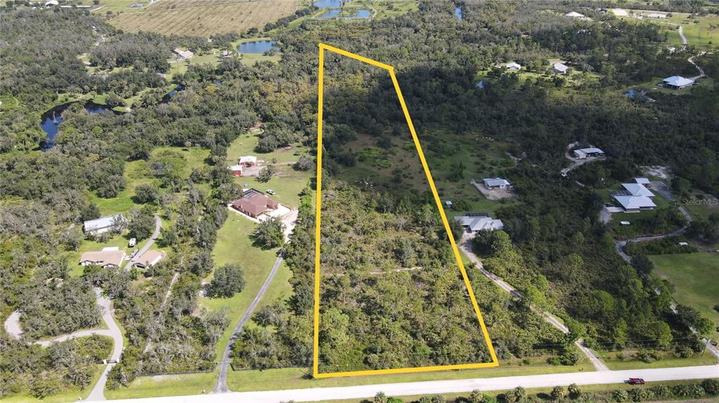 An aerial view shows a large, rectangular plot of land outlined in yellow — 15650 WATER OAK COURT, PUNTA GORDA, FL