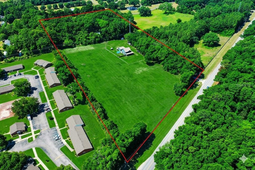 An aerial view shows a house situated on a large, rectangular, grass-covered lot — 13576 NW COUNTY ROAD 235, ALACHUA, FL