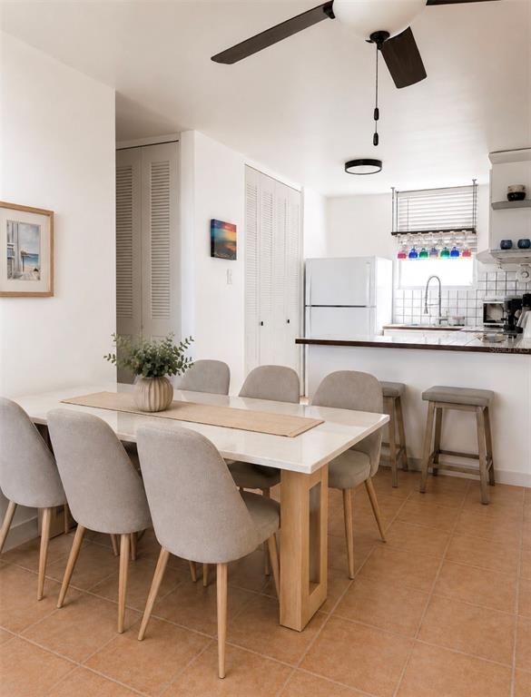 A dining area with a light-colored table and chairs sits adjacent to a white kitchen — 5015 PUNTA TUNA UNIT 309, MAUNABO, PR