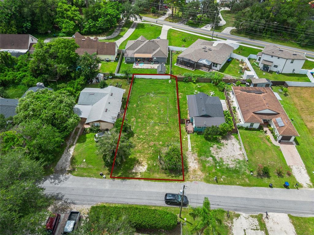An aerial view shows a vacant rectangular residential lot outlined in red between two houses — 10130 FRANKEL STREET, ORLANDO, FL