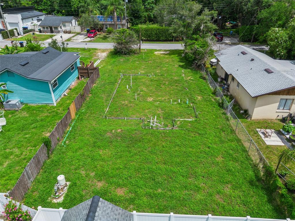 An aerial view shows a vacant residential lot with a foundation outline between two houses — 10130 FRANKEL STREET, ORLANDO, FL