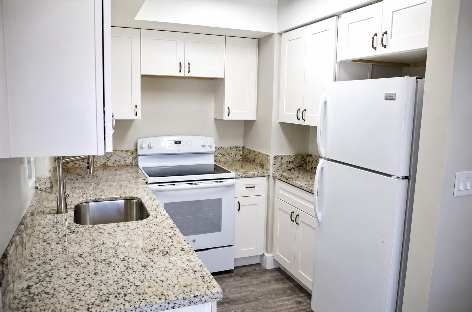 A kitchen with white cabinets, granite countertops, a white stove, and a white refrigerator — 2120 NE 41st Street # D, Lighthouse Point FL 33064, LIGHTHOUSE POINT, FL