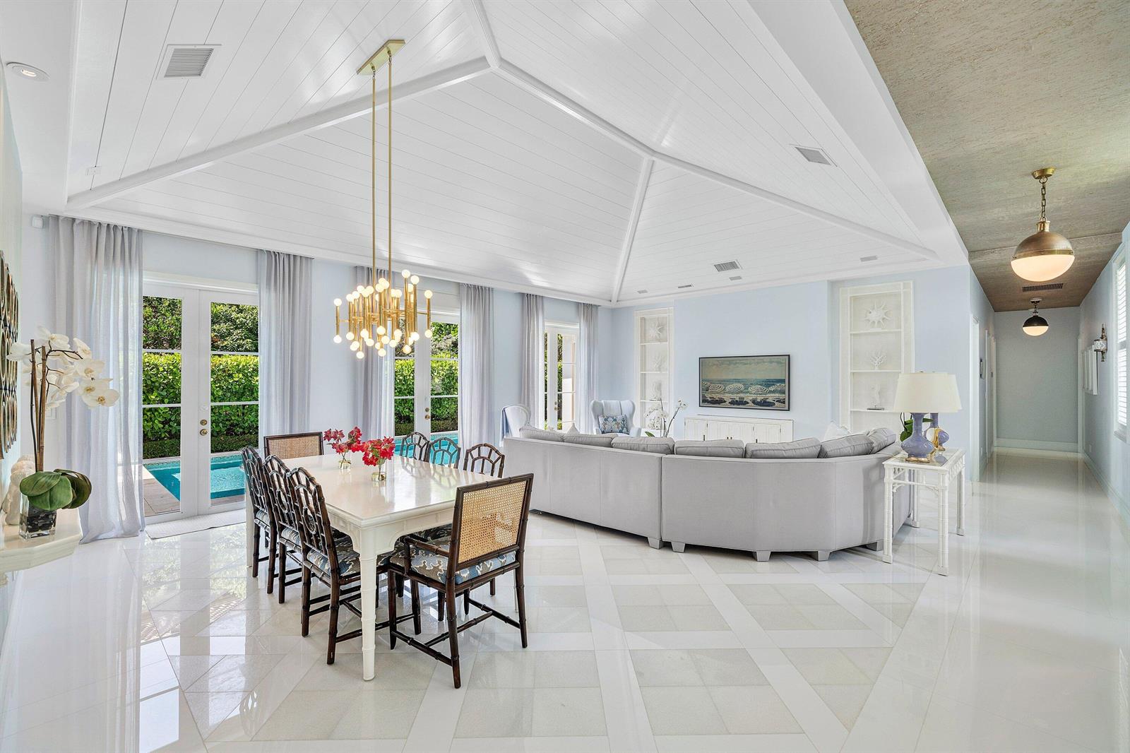 A bright, open-concept dining and living area features a vaulted ceiling and marble floors — 106 Beachway Drive, Ocean Ridge FL 33435, OCEAN RIDGE, FL