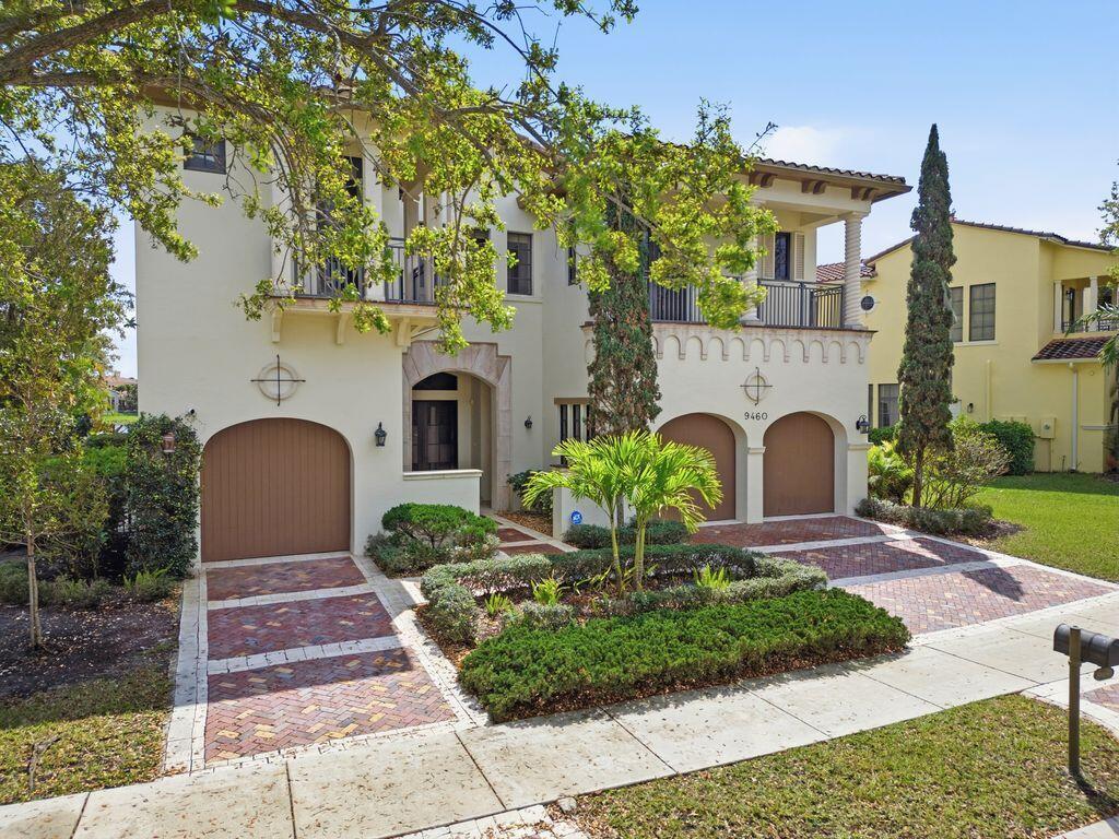 A two-story stucco house features a three-car garage and a brick-paved driveway — 9460 Eden Manor, Parkland FL 33076, PARKLAND, FL