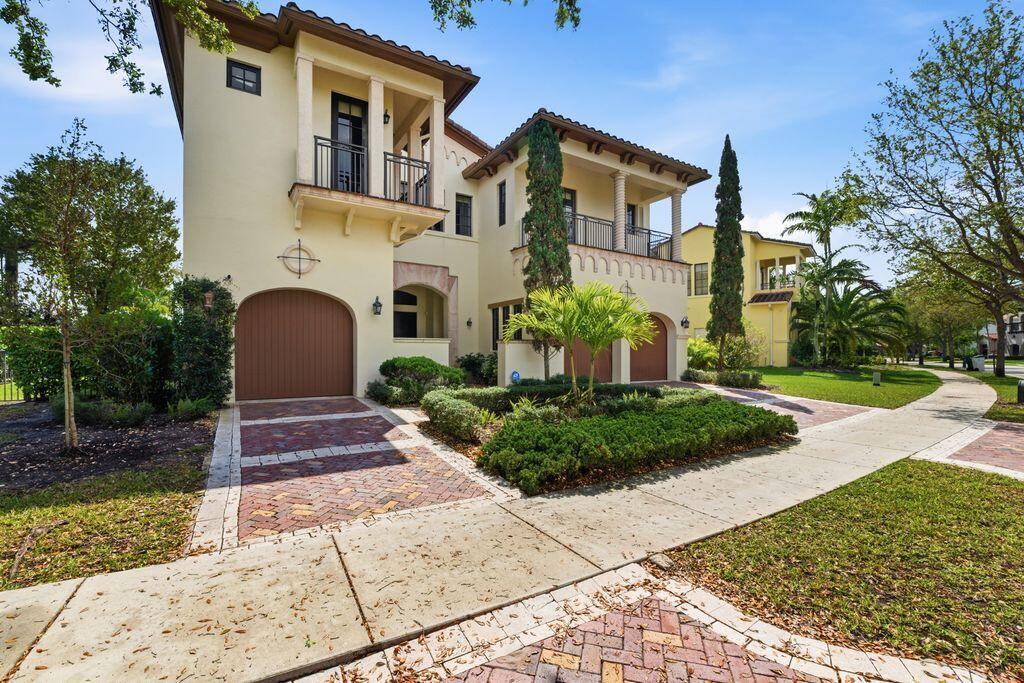 A two-story Mediterranean-style house with a three-car garage and a brick-paved driveway — 9460 Eden Manor, Parkland FL 33076, PARKLAND, FL