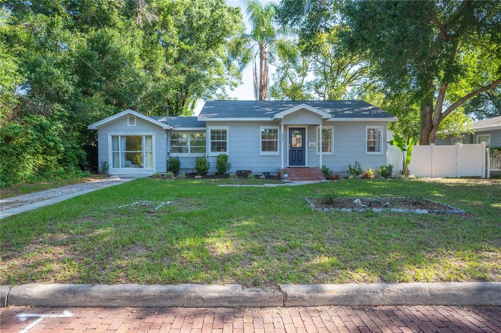 A light gray single-story house with a brick walkway and a large front lawn — 1037 JOSEPHINE STREET, LAKELAND, FL