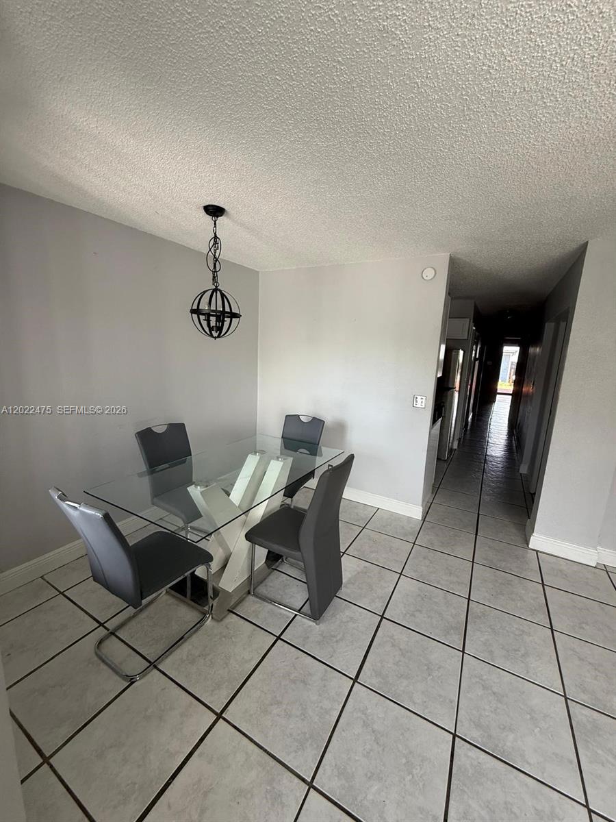 An empty room features light gray walls, white tile flooring, and a ceiling fan — 9116 NW 35th Pl # 0, Sunrise FL 33351, SUNRISE, FL