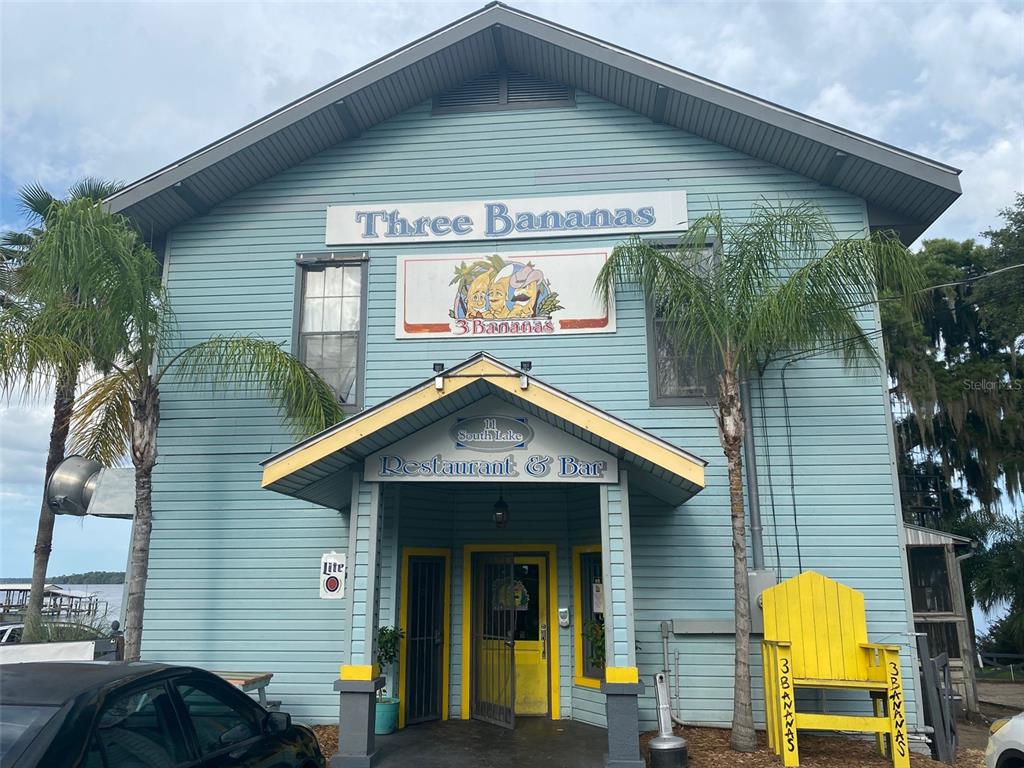 The exterior of a light blue two-story restaurant building with a yellow-trimmed entrance — 709 GEORGETOWN DENVER ROAD, CRESCENT CITY, FL