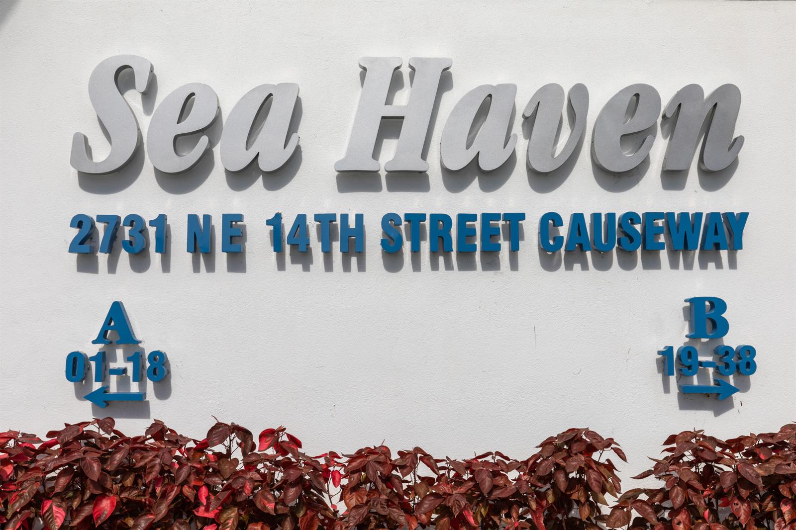 A sign for Sea Haven displays unit numbers and directional arrows against a white wall — 2731 NE 14th St Causeway # 532, Pompano Beach FL 33062, POMPANO BEACH, FL
