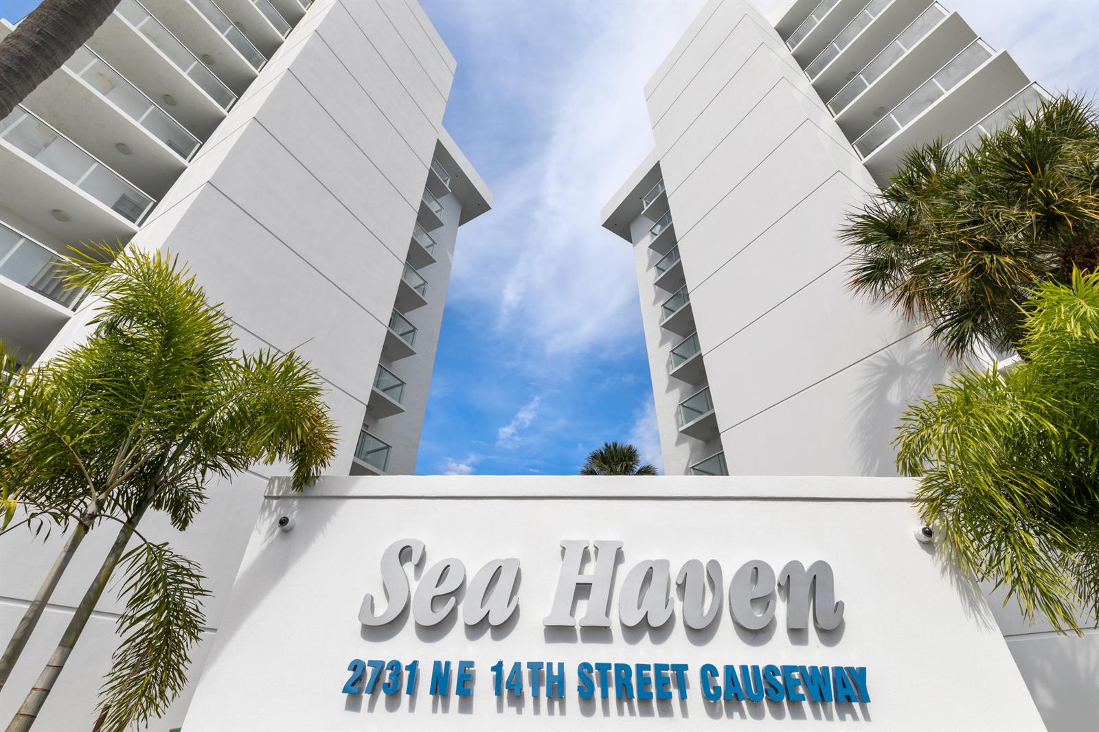 The exterior of a white multi-story apartment building features palm trees and a prominent sign — 2731 NE 14th St Causeway # 532, Pompano Beach FL 33062, POMPANO BEACH, FL
